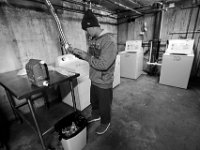 Navy veteran, Steve Viveiros, reads the directors on the bottle of detergent as he prepares to do laundry at the Veterans Transition House in New Bedford.  The VTH is currently located inside the former rectory of the St John the Baptist church on County Street in New Bedford which was the first Portuguese catholic church in the United States, and has been unoccupied since 2012.  Steve who has been living at the VTH for the last six months, is trying to get back on his feet, and has recently found a job working at a local hotel.  PHOTO PETER PEREIRA